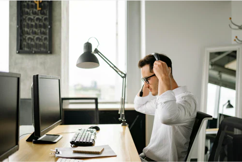 Dangers of sedentarity and how to fight it. Man sitting in front of his desk