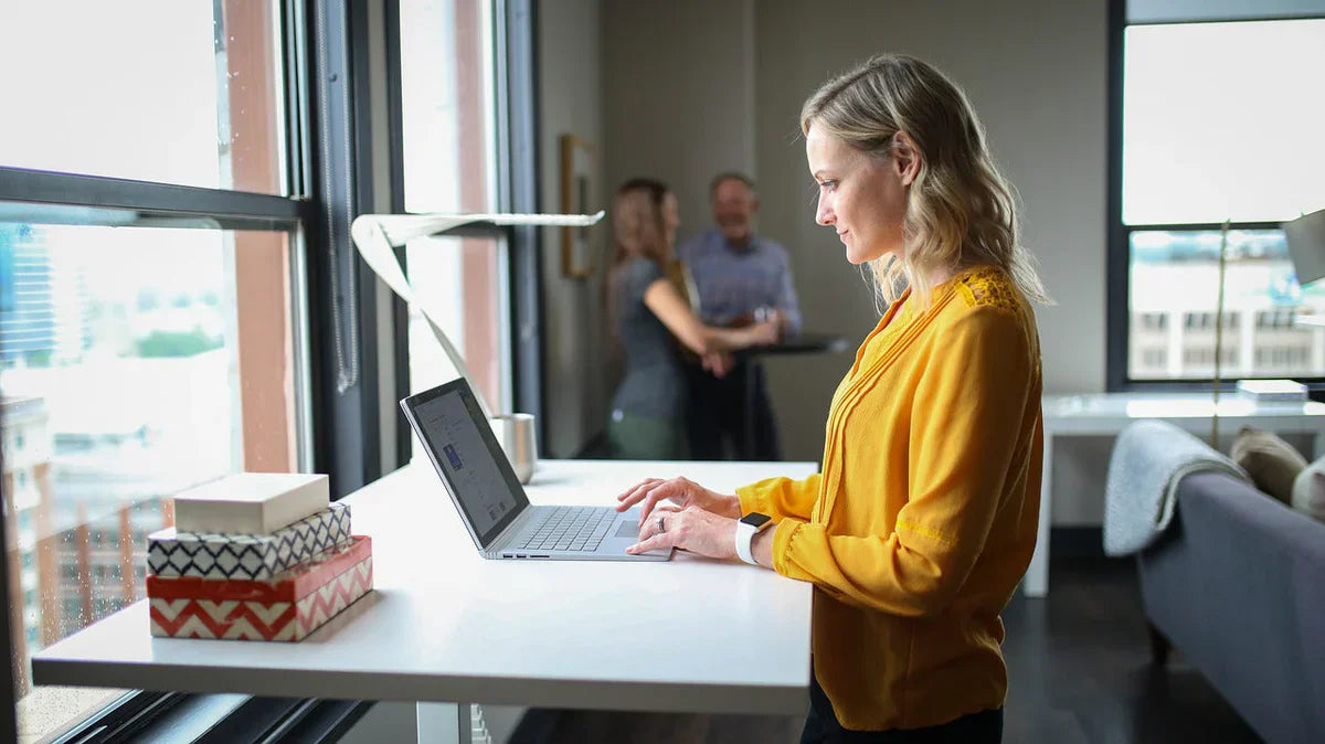 Standing at work : woman working while standing in front of a standing desk