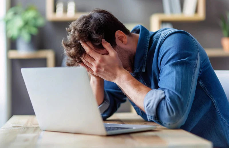 work fatigue : a man exhausted at his desk